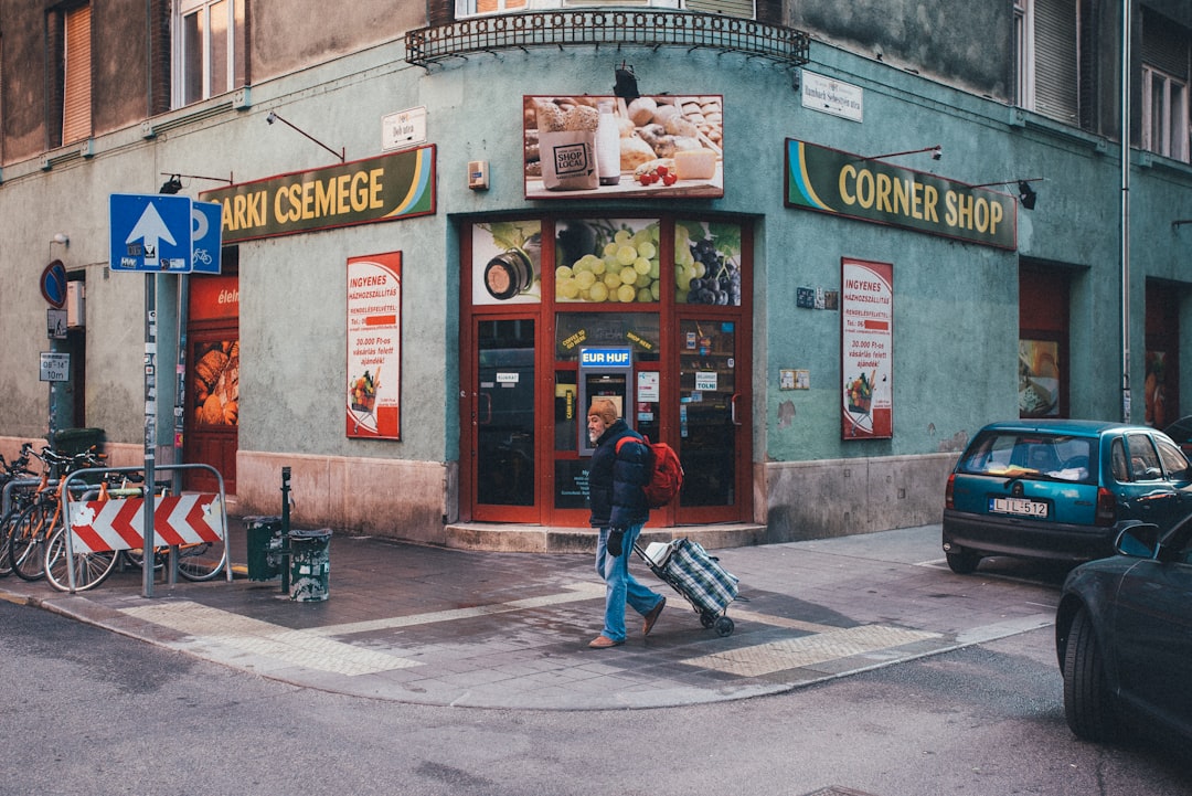 a man walking down a street carrying a suitcase