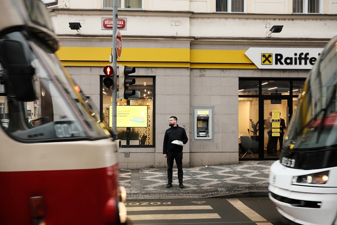 Man standing between two trams at a crosswalk