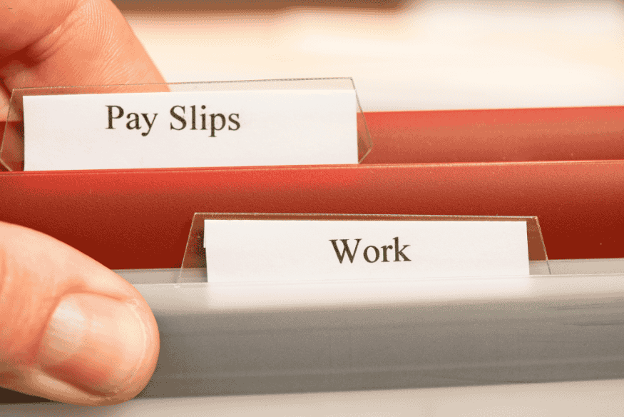 Classeurs étiquetés “Pay Slips” et “Work” représentant des documents administratifs professionnels.