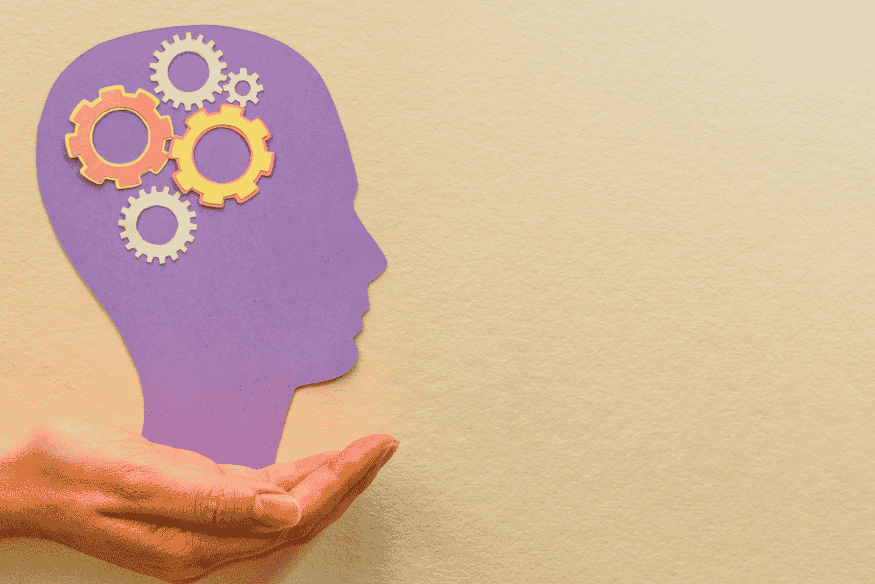 Illustration du lien entre psychologie et argent avec un cerveau symbolisé par des engrenages dans une tête.